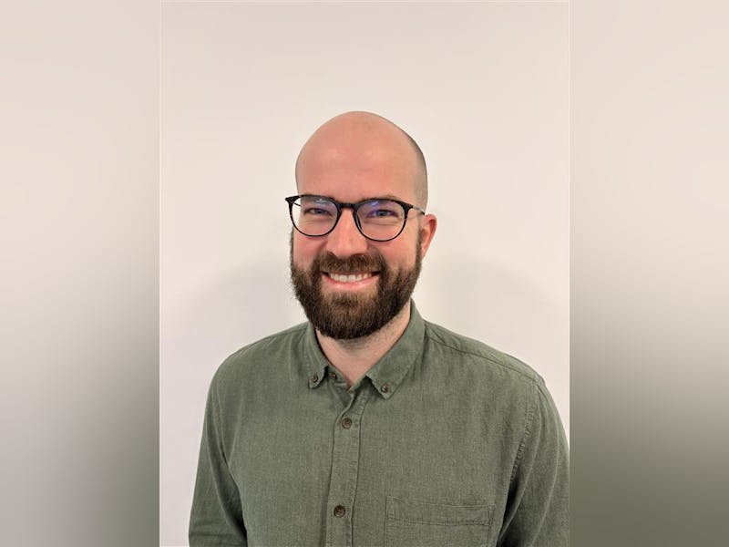 Portrait of Casper Barner, a ServiceNow professional, wearing glasses and a green shirt.