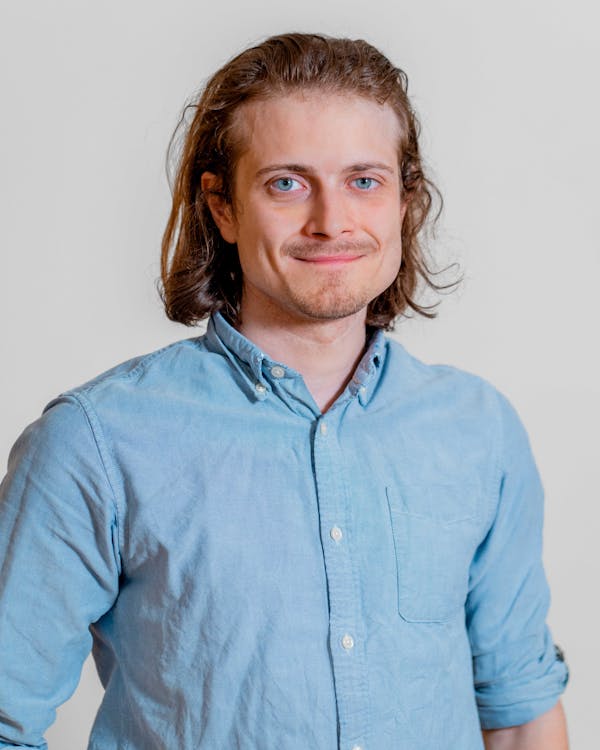 Portrait of Jan Winther, a ServiceNow professional, wearing a light blue button-down shirt.