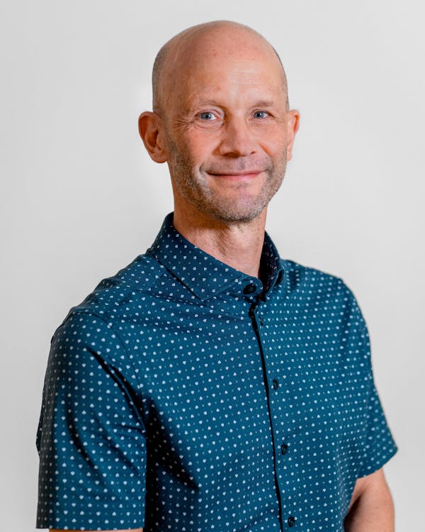 Portrait of Martin Green, a ServiceNow professional, wearing a blue patterned shirt.
