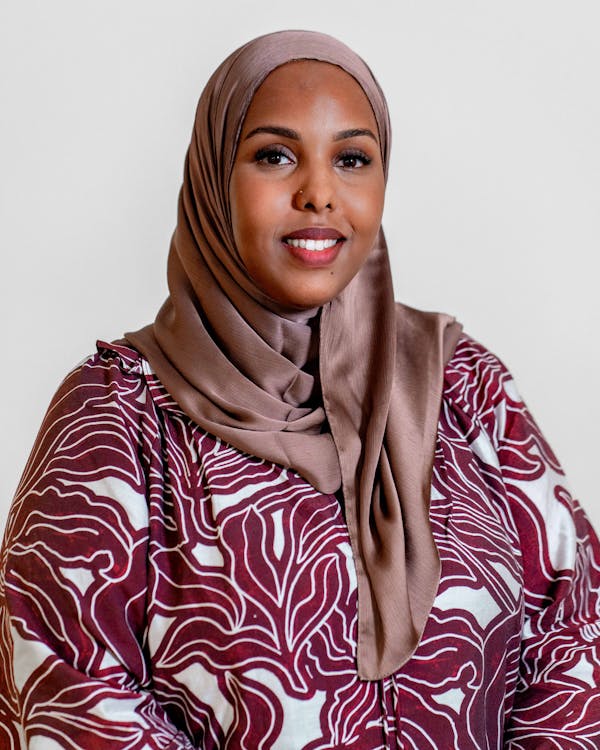 Portrait of Muna Ahmed Mohammed, a ServiceNow professional, wearing a hijab and a patterned top.