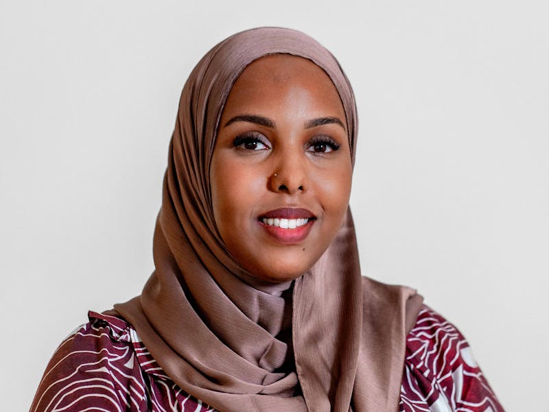 Portrait of Muna Ahmed Mohammed, a ServiceNow professional, wearing a hijab and a patterned top.