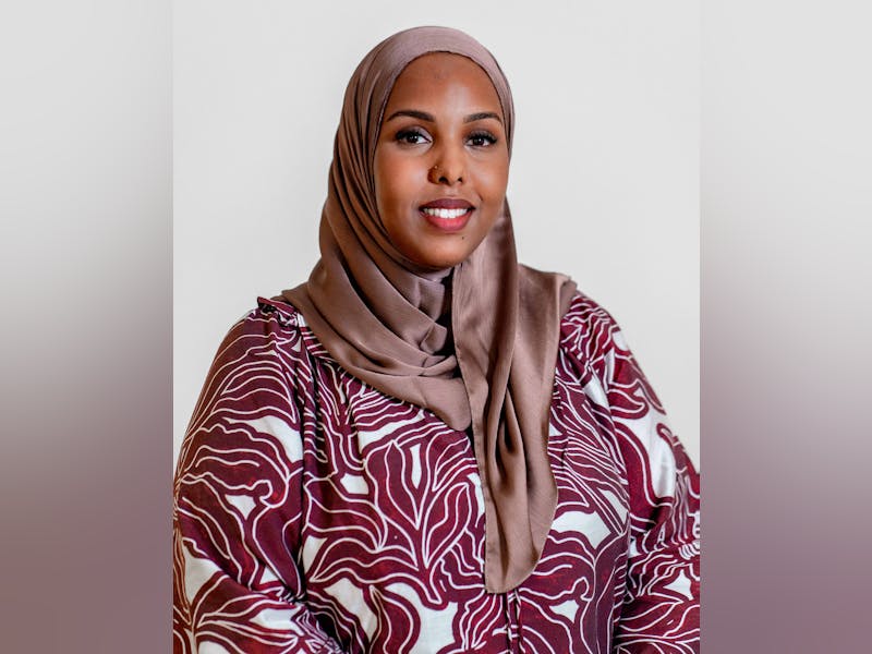 Portrait of Muna Ahmed Mohammed, a ServiceNow professional, wearing a hijab and a patterned top.