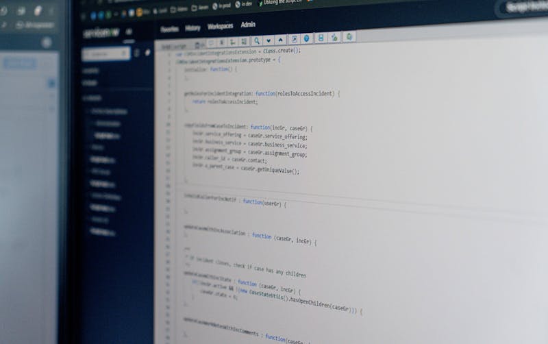A computer screen displaying code within the ServiceNow platform interface.