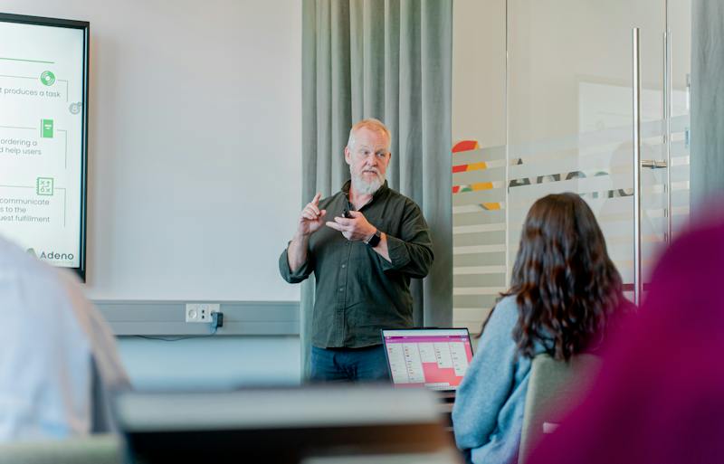 A man with a white beard presenting a ServiceNow training session.
