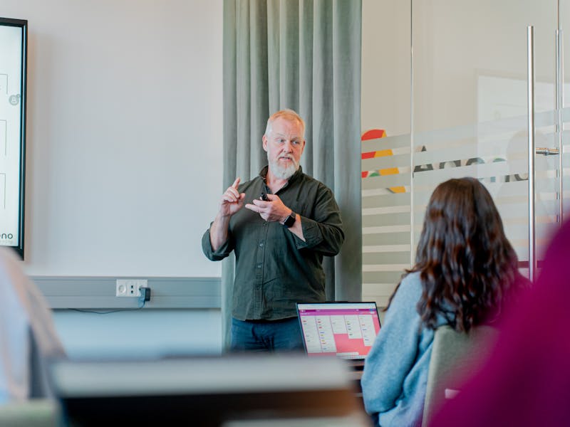 A man with a white beard presenting a ServiceNow training session.