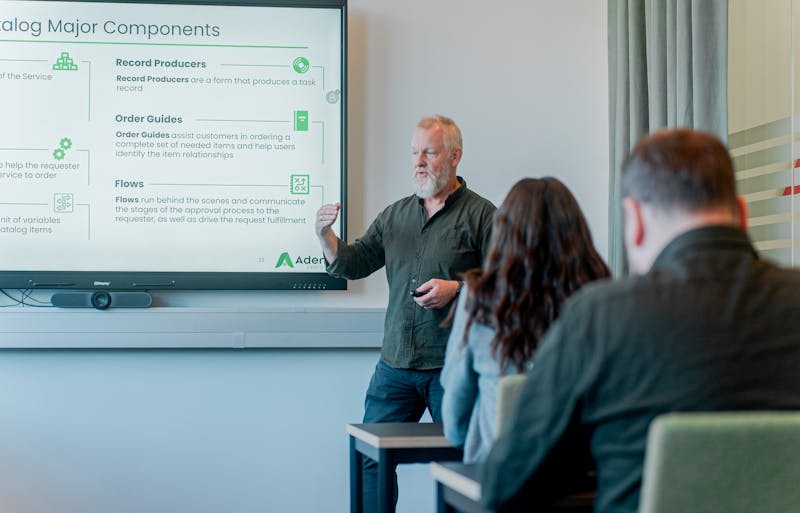 A man giving a presentation about ServiceNow Catalog Major Components to an audience.