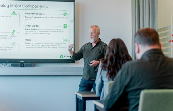 A man giving a presentation about ServiceNow Catalog Major Components to an audience.