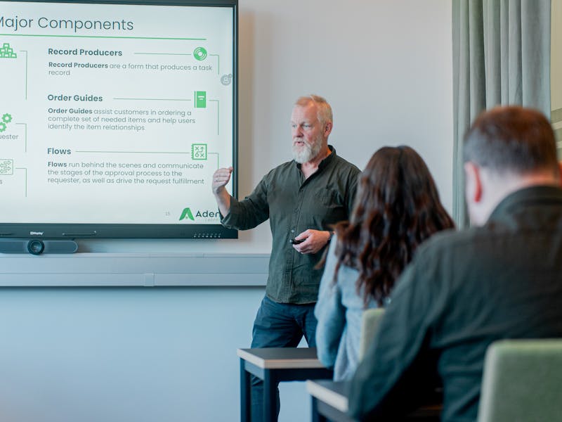 A man giving a presentation about ServiceNow Catalog Major Components to an audience.
