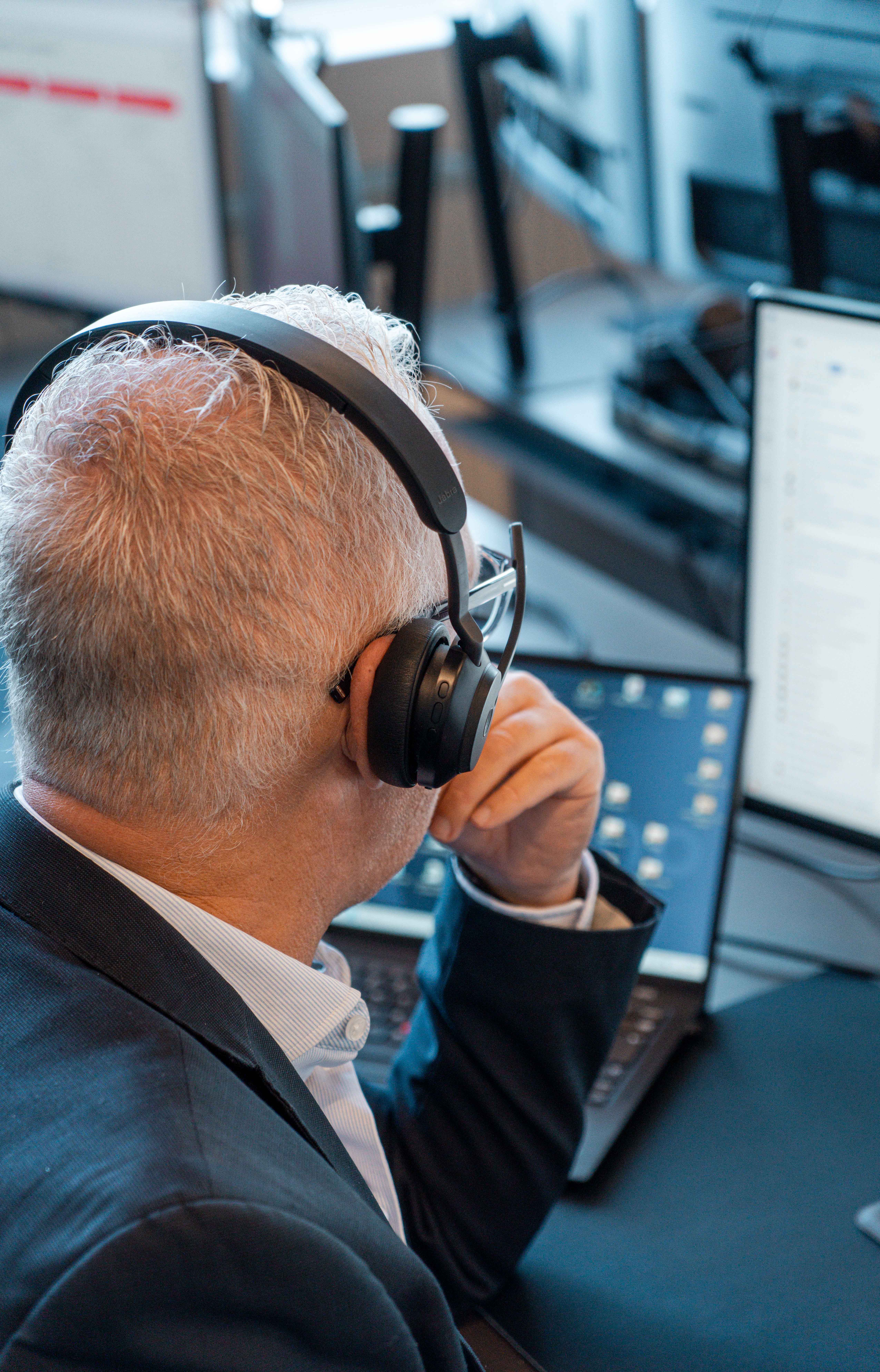 A ServiceNow professional wearing a headset and working at a computer.