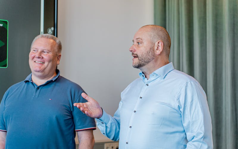 Two men in a professional setting discussing ServiceNow.