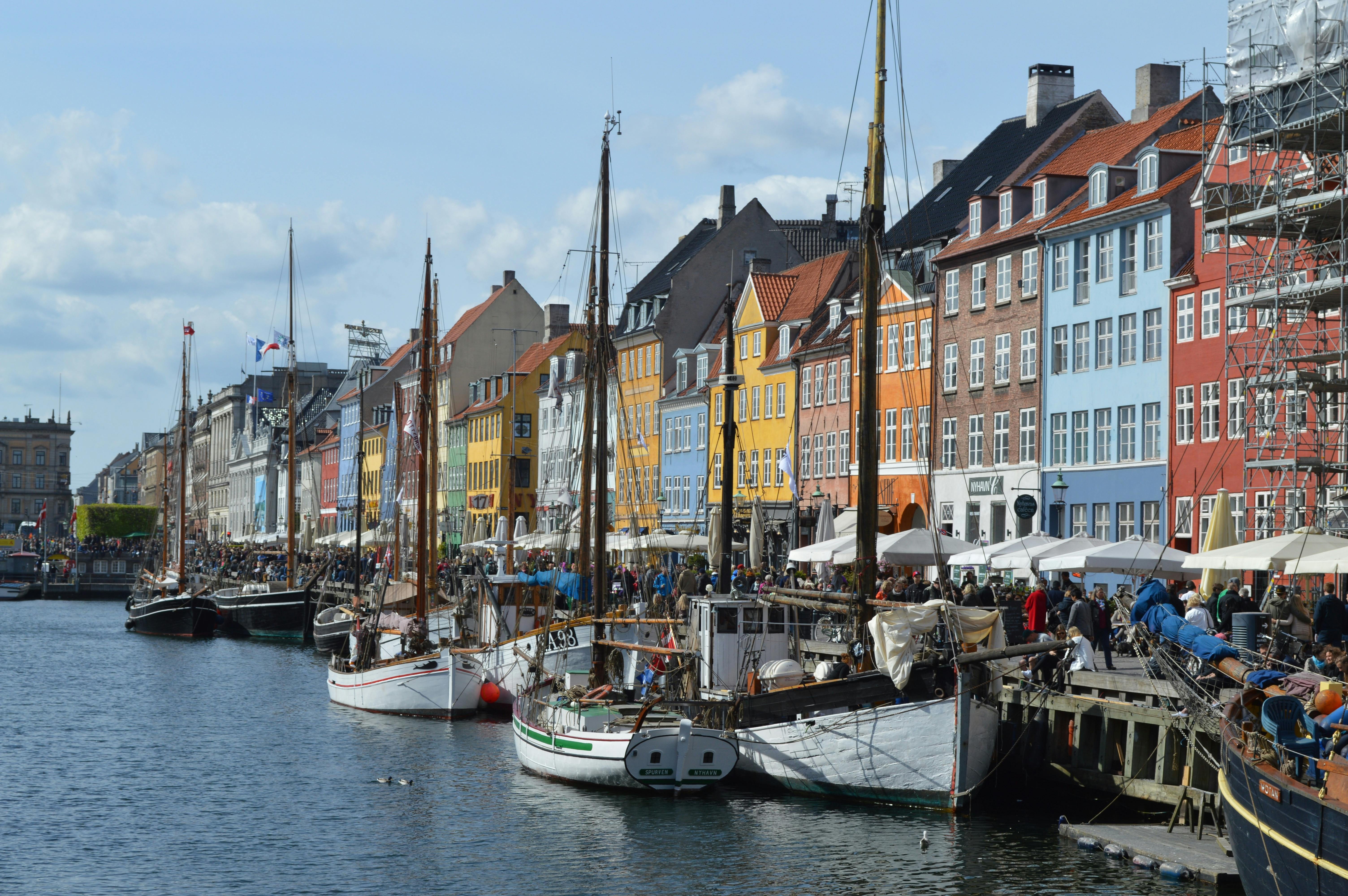 Colorful buildings and wooden boats at Nyhavn canal in Copenhagen, the site for a ServiceNow developer meetup.
