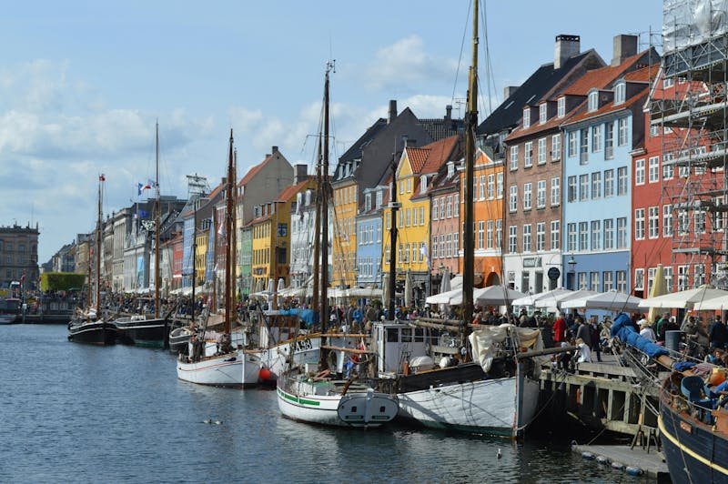 Colorful buildings and wooden boats at Nyhavn canal in Copenhagen, the site for a ServiceNow developer meetup.