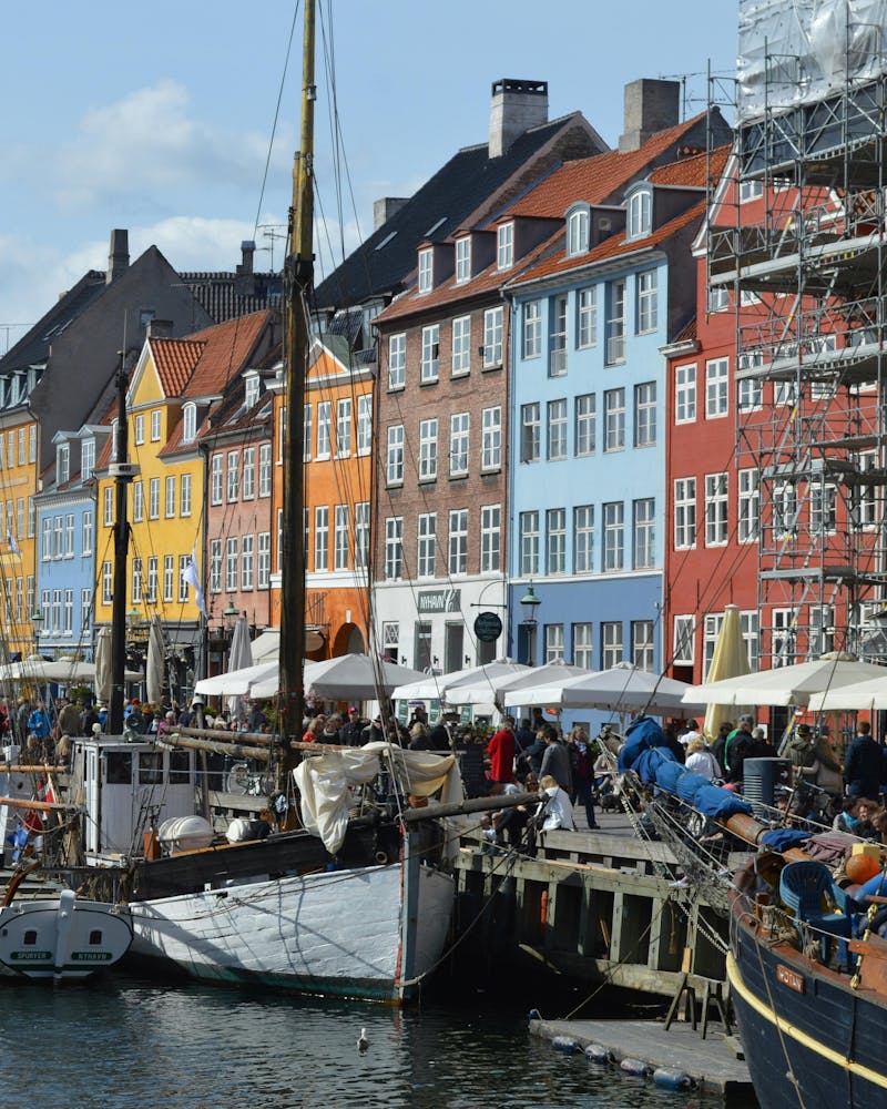 Colorful buildings and wooden boats at Nyhavn canal in Copenhagen, the site for a ServiceNow developer meetup.