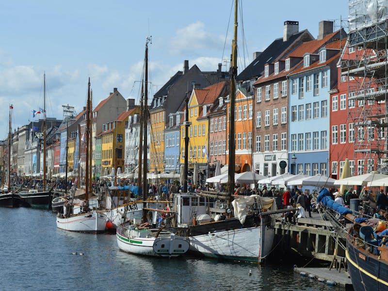 Colorful buildings and wooden boats at Nyhavn canal in Copenhagen, the site for a ServiceNow developer meetup.