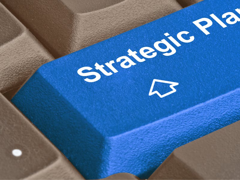 A blue keyboard key with the text 'Strategic Plan' and an upward arrow icon for a ServiceNow strategic plan.