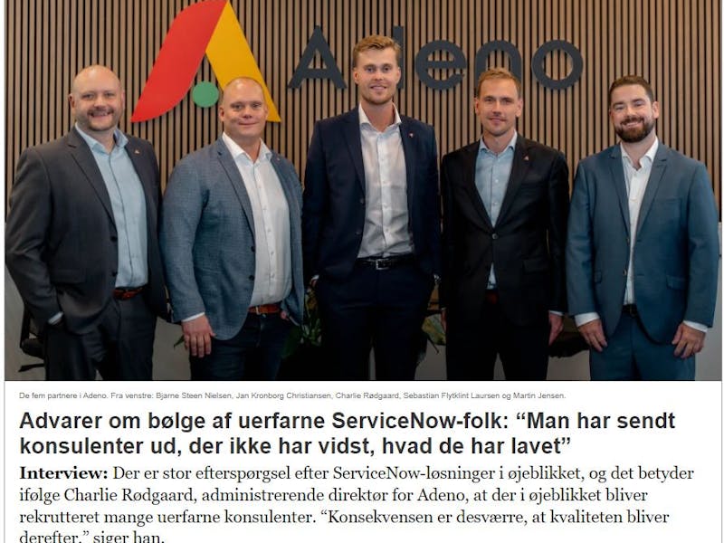 Five partners from Adeno, a ServiceNow partner, standing in front of the company logo.