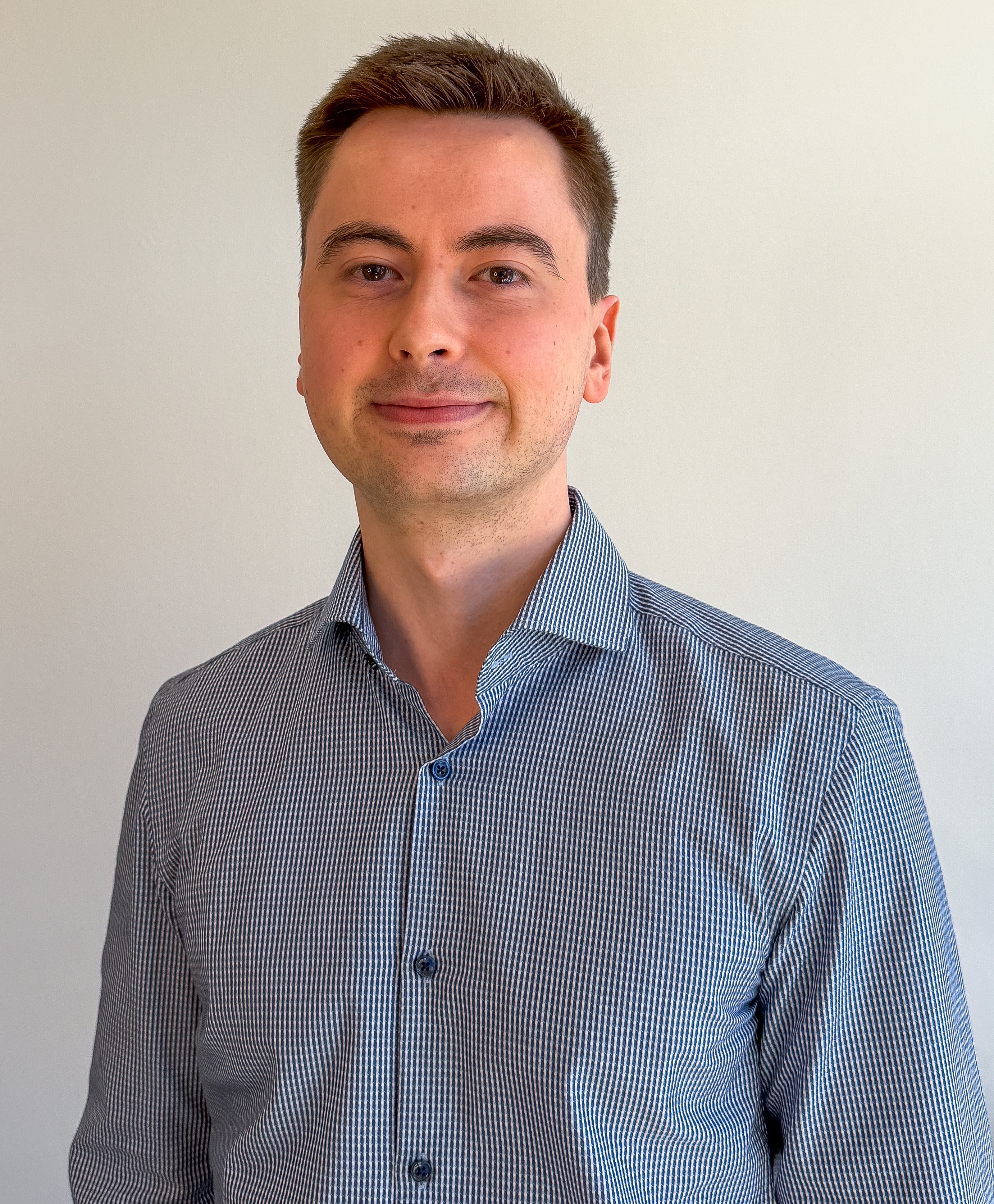 Portrait of Frederik Viuf Christiansen, a ServiceNow professional, wearing a blue and white striped shirt.