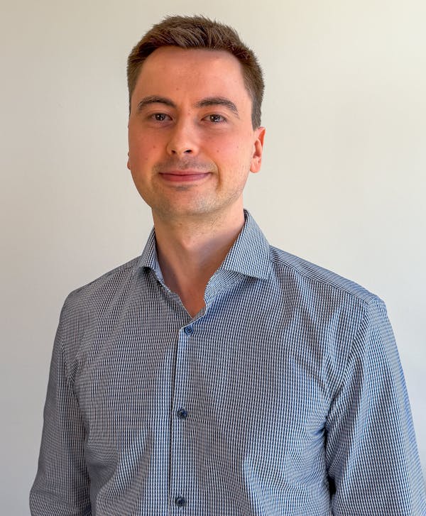 Portrait of Frederik Viuf Christiansen, a ServiceNow professional, wearing a blue and white striped shirt.