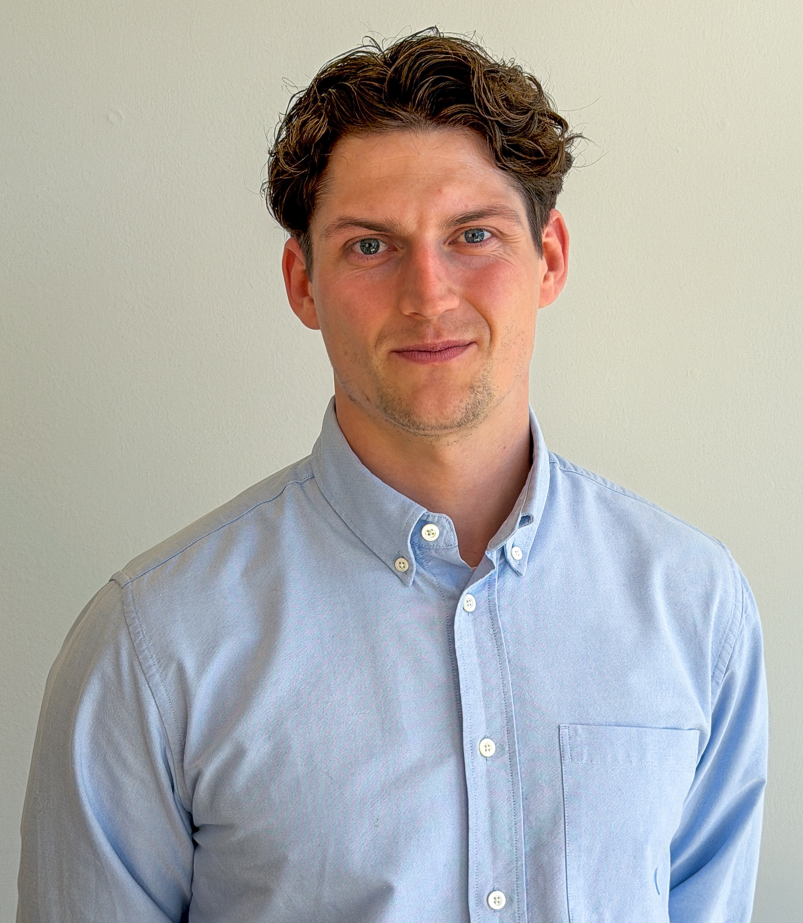 Portrait of Martin Krabbe Nielsen, a ServiceNow professional, wearing a light blue button-down shirt.