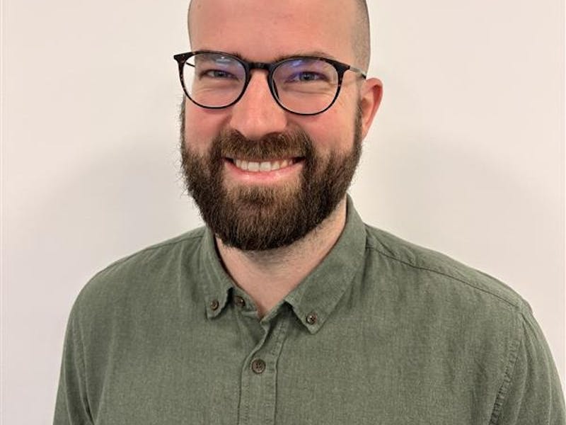 Portrait of Casper Barner, a ServiceNow professional, wearing glasses and a green shirt.