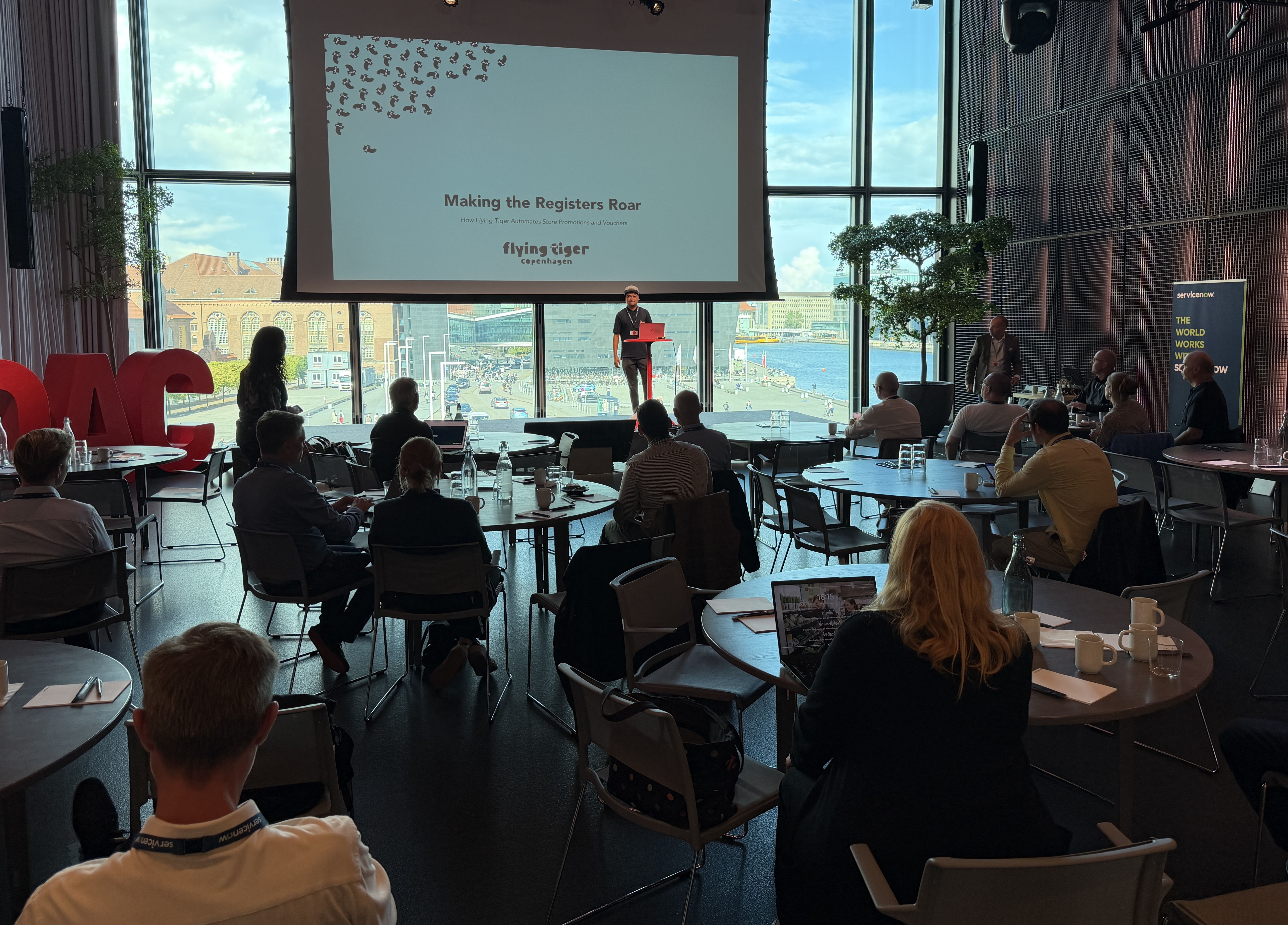 A graphic titled Making the Registers Roar describing how Flying Tiger Copenhagen automates store promotions and vouchers using ServiceNow.