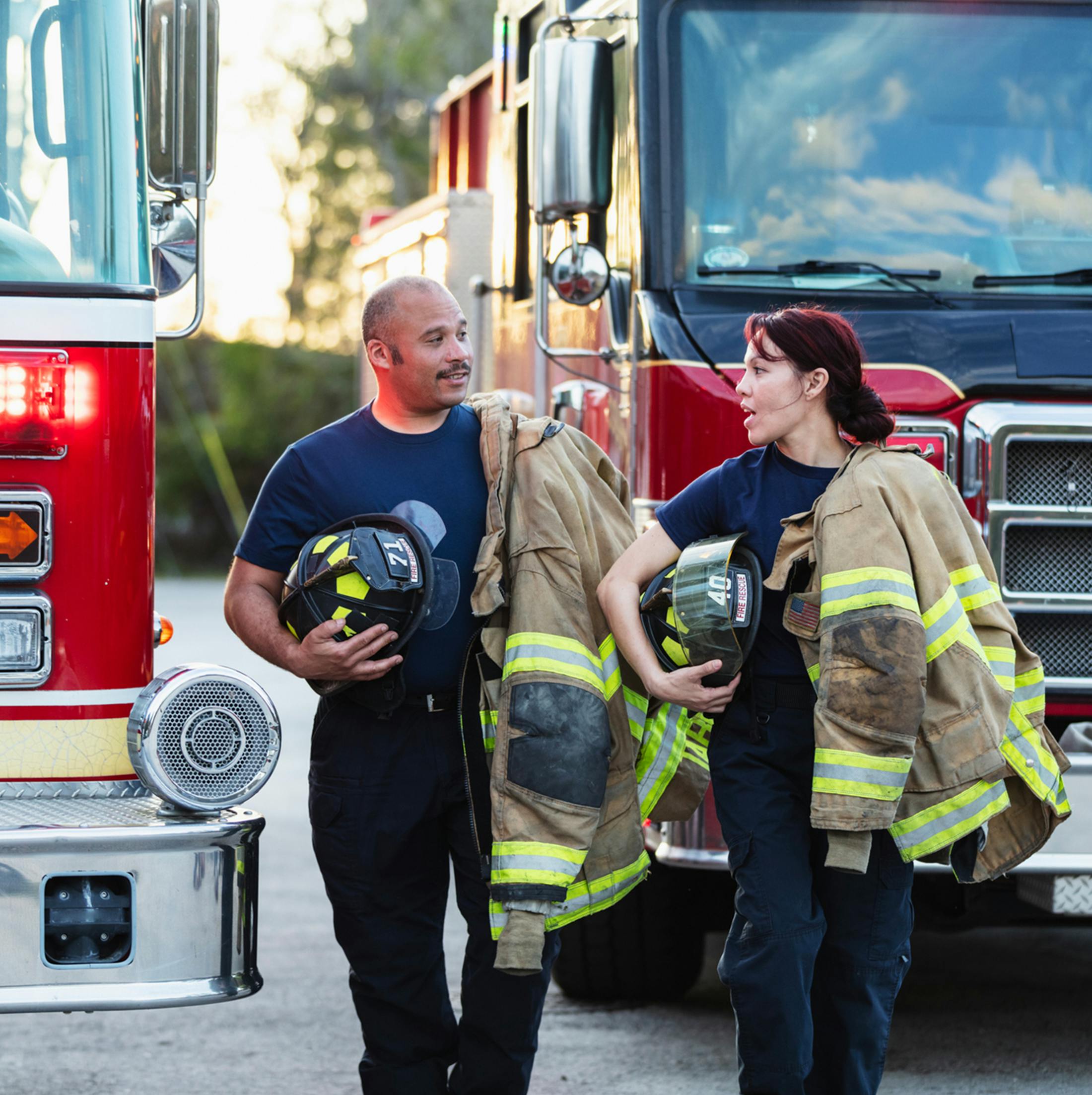 fire fighters holding their gear