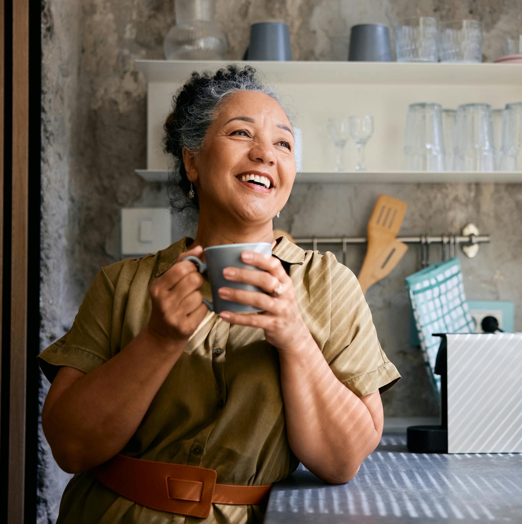 Women smiling holding mug