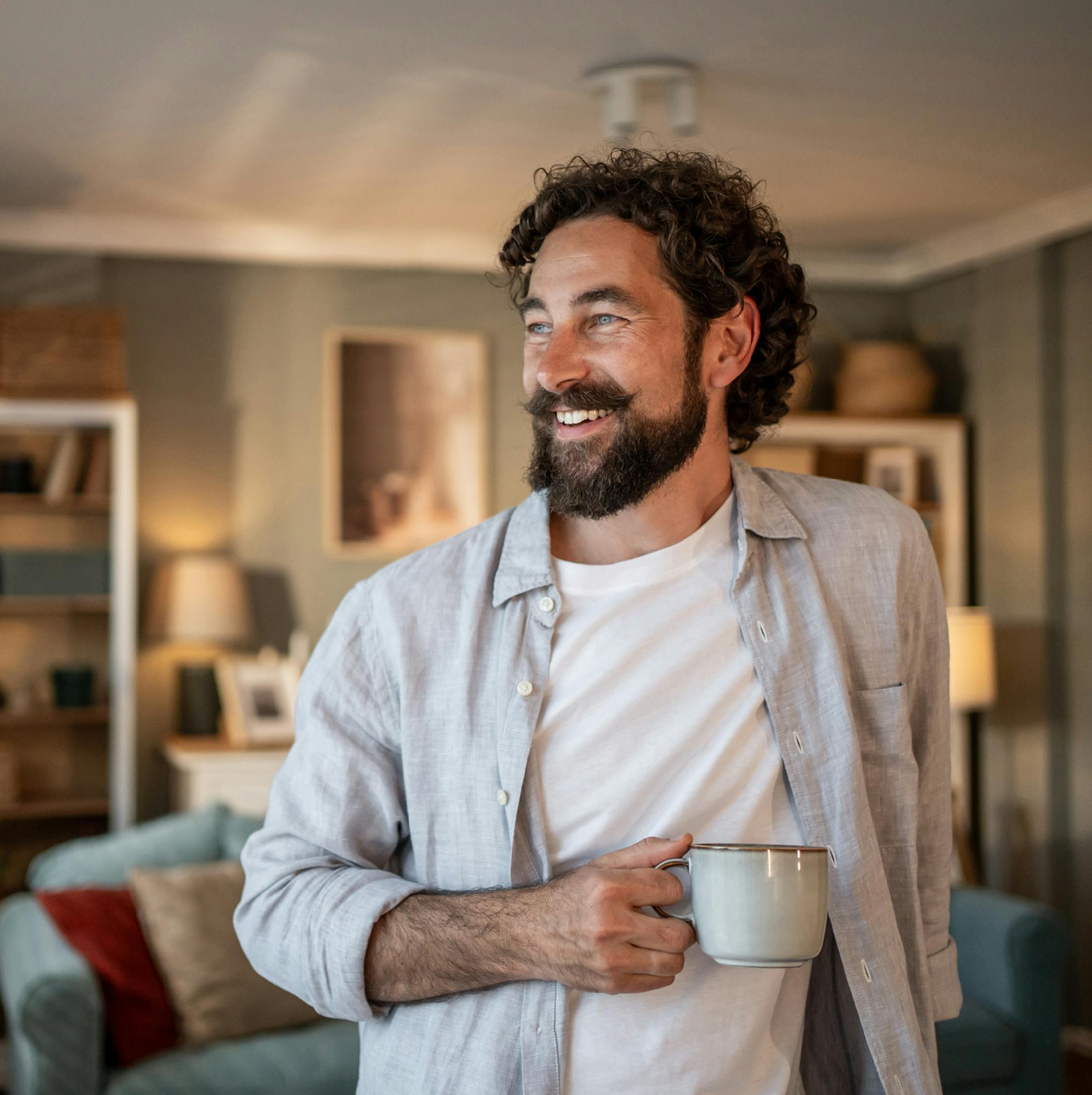 Man smiling holding mug