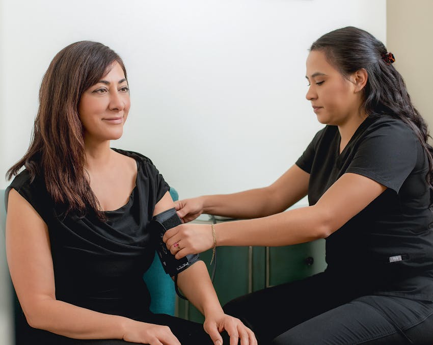 woman getting her blood pressure checked