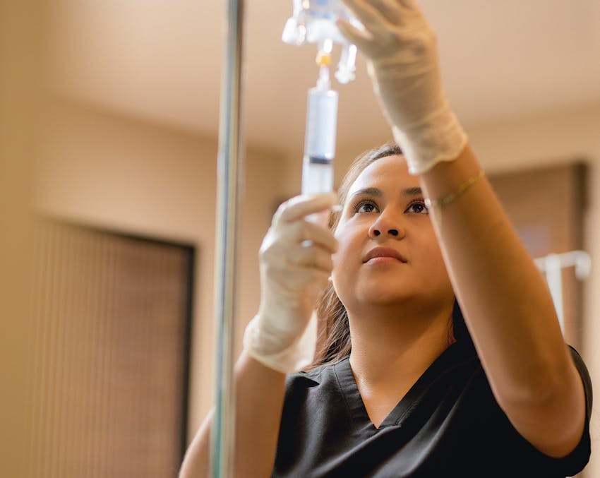 nurse filling up an IV bag