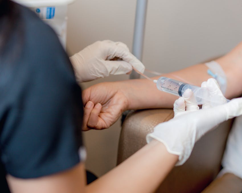 woman injecting a patient