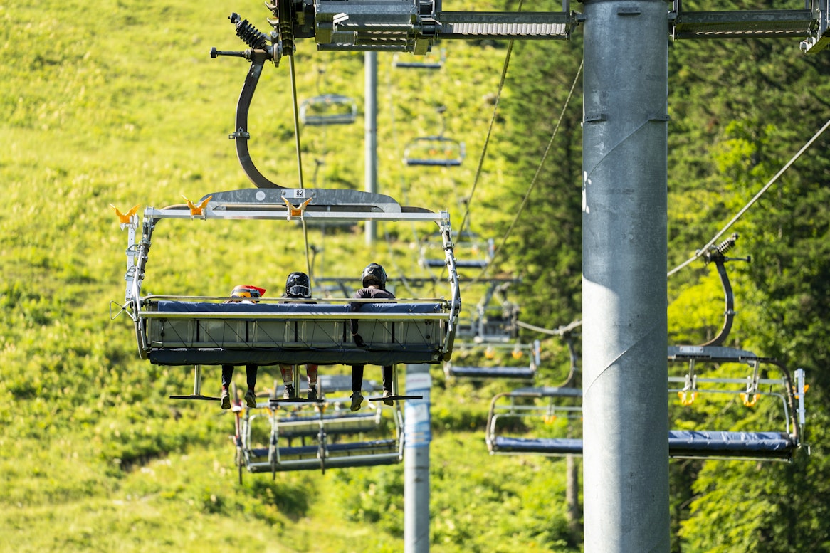 A family on a chairlift on their way up to the summit of Morond