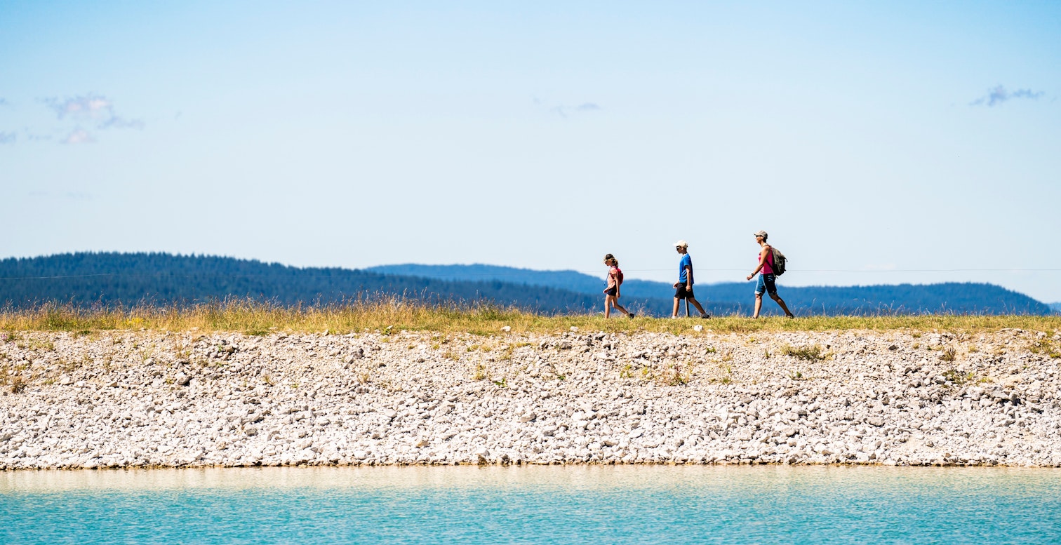 a family out for a walk by the lake
