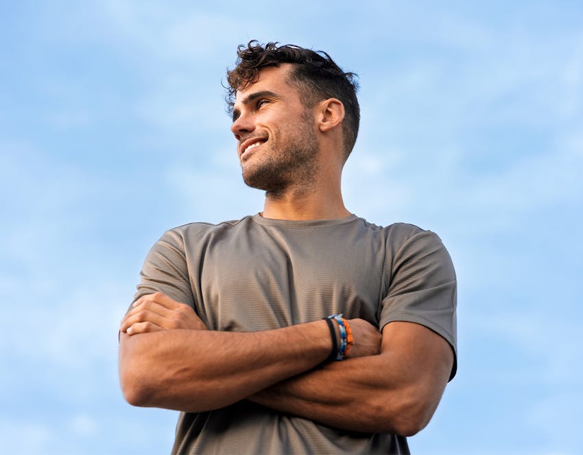 A man looking off to the side with his arms crossed