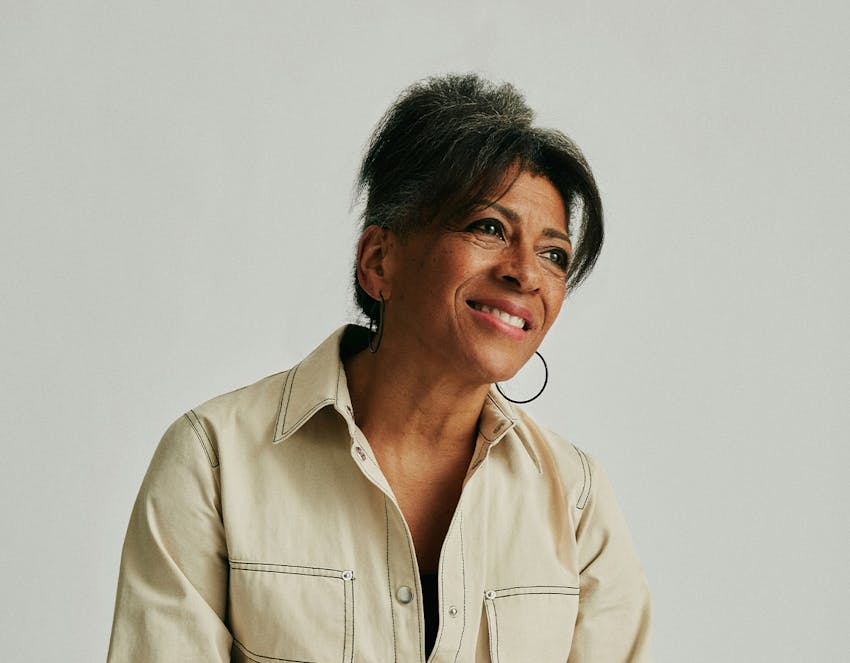 A woman smiling and looking off to the side