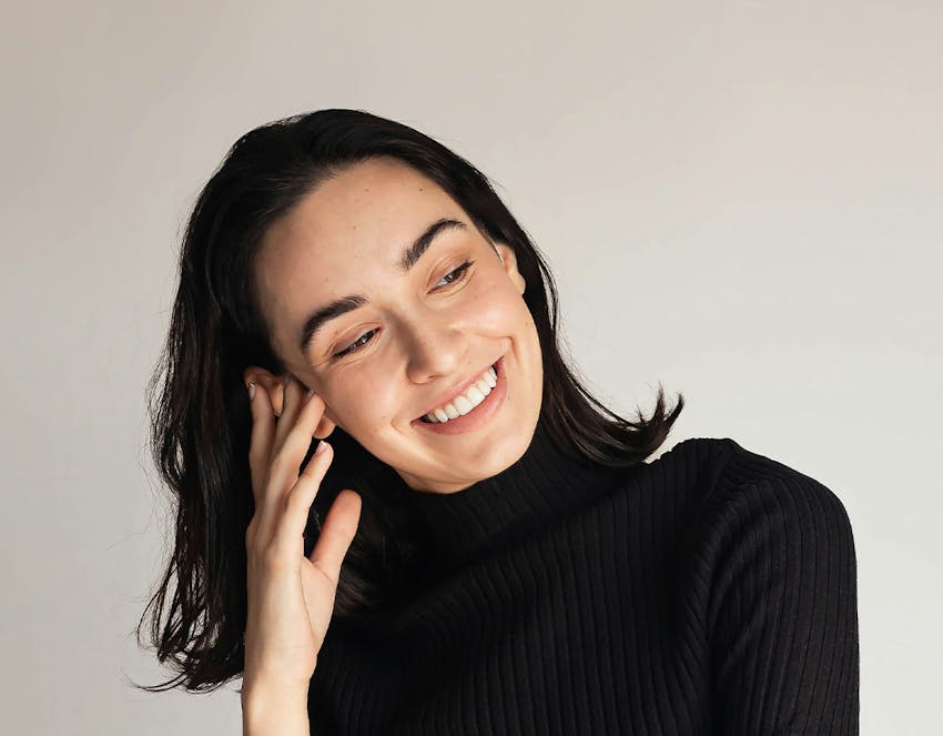 A woman touching her face