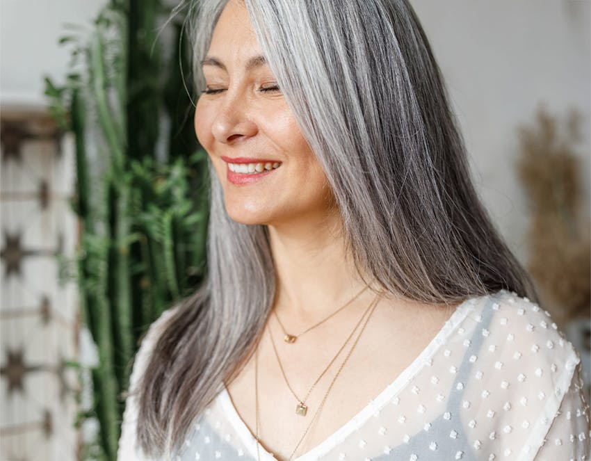 A woman smiling with her eyes closed