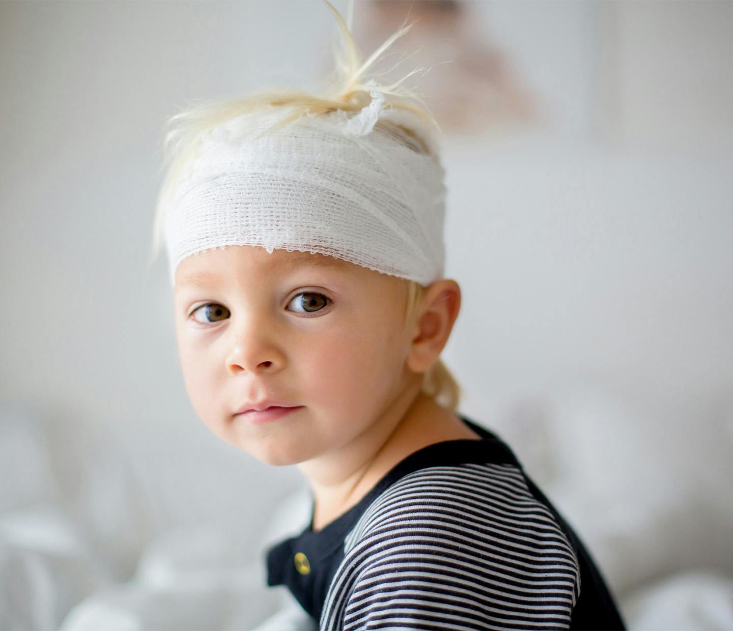 child with head bandaged