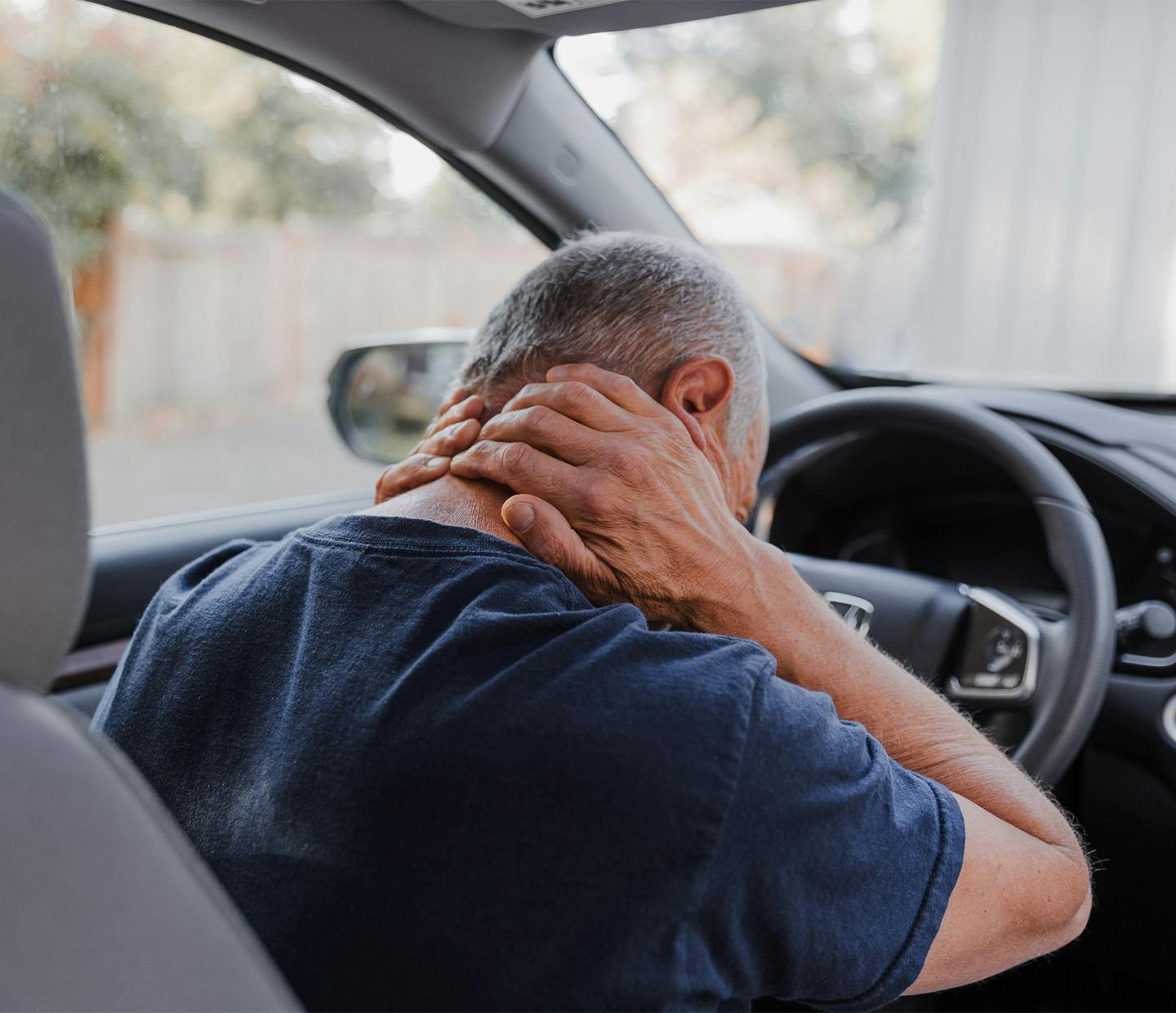 a man holding his neck