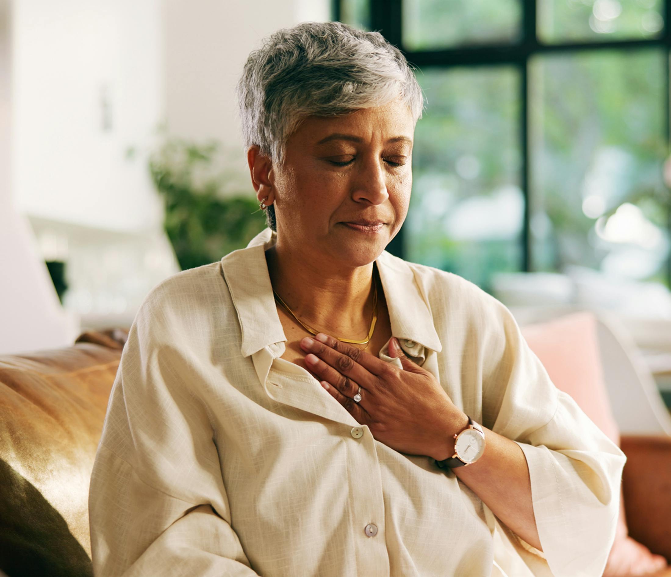 woman clutching chest