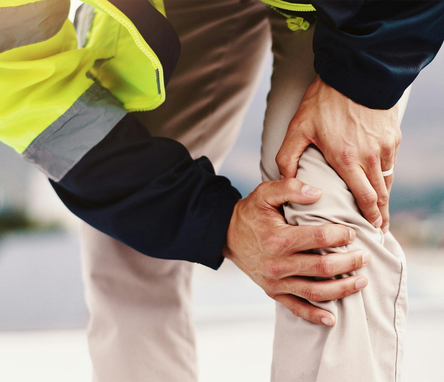 construction worker grabbing knee