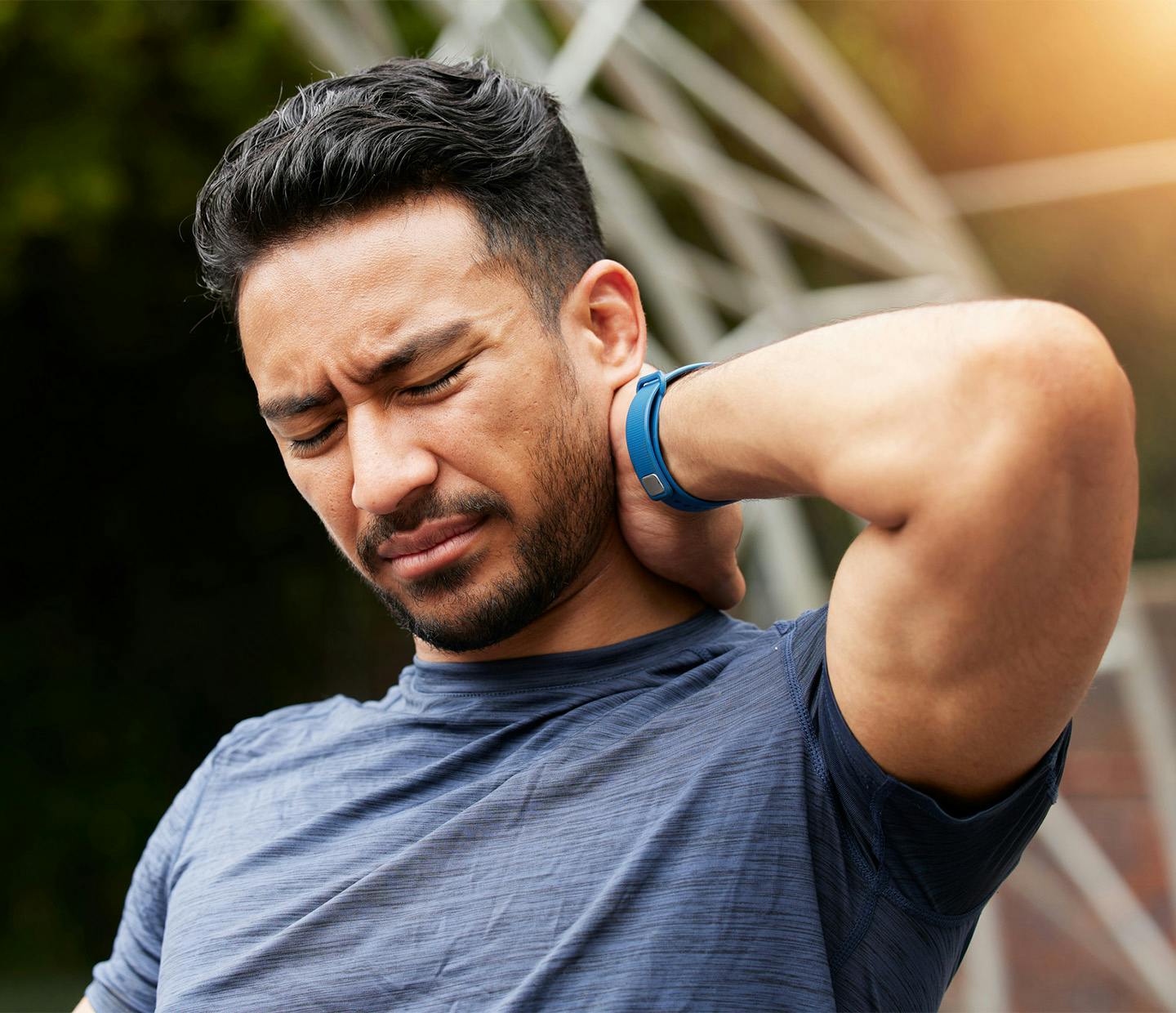 man holding his neck in pain