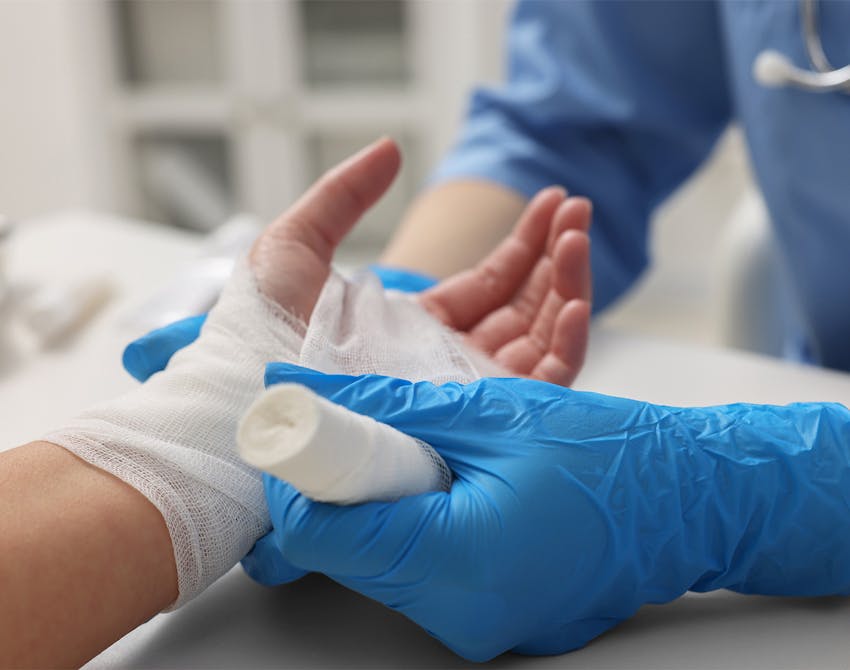 doctor bandaging a hand