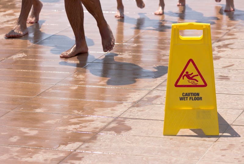 Caution wet floor sign at a pool