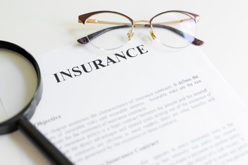 Magnifying glass,eyeglasses and insurance letter