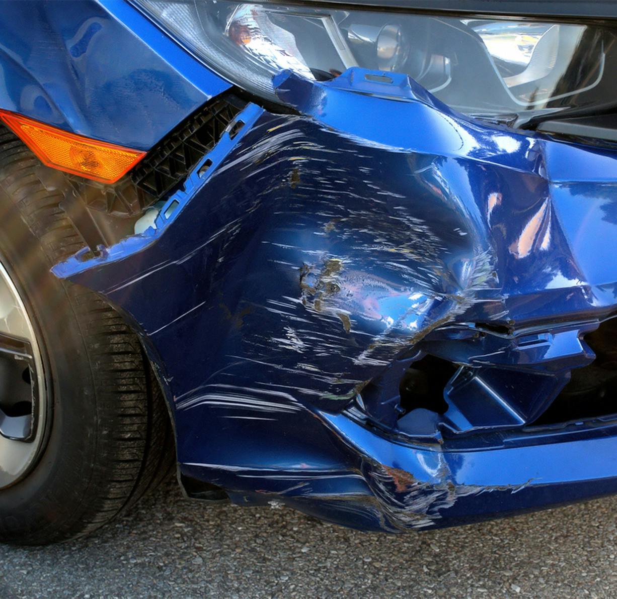 A crashed blue car