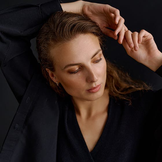 woman with her hands behind her head