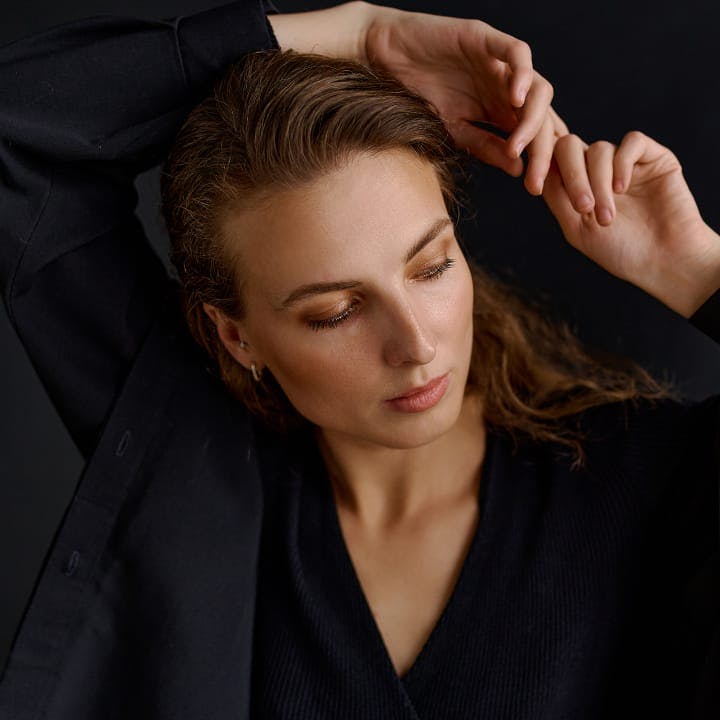 woman with her hands behind her head