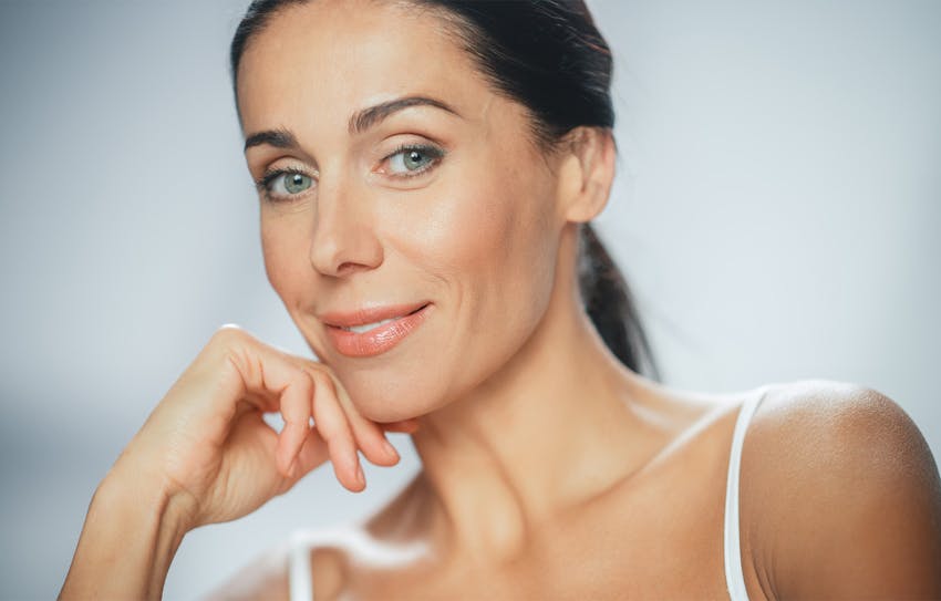 woman with hand on face