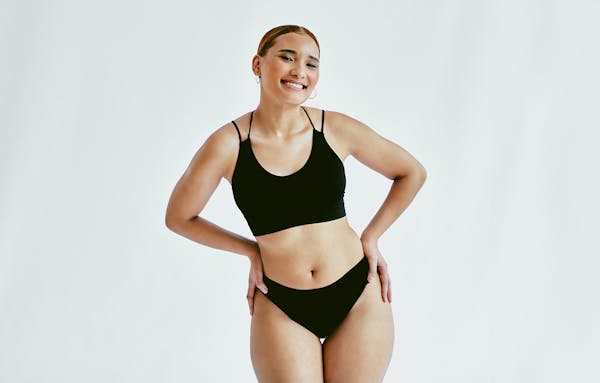 woman smiling with hands on hips